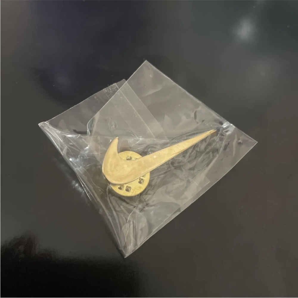 Nike gold swoosh pin